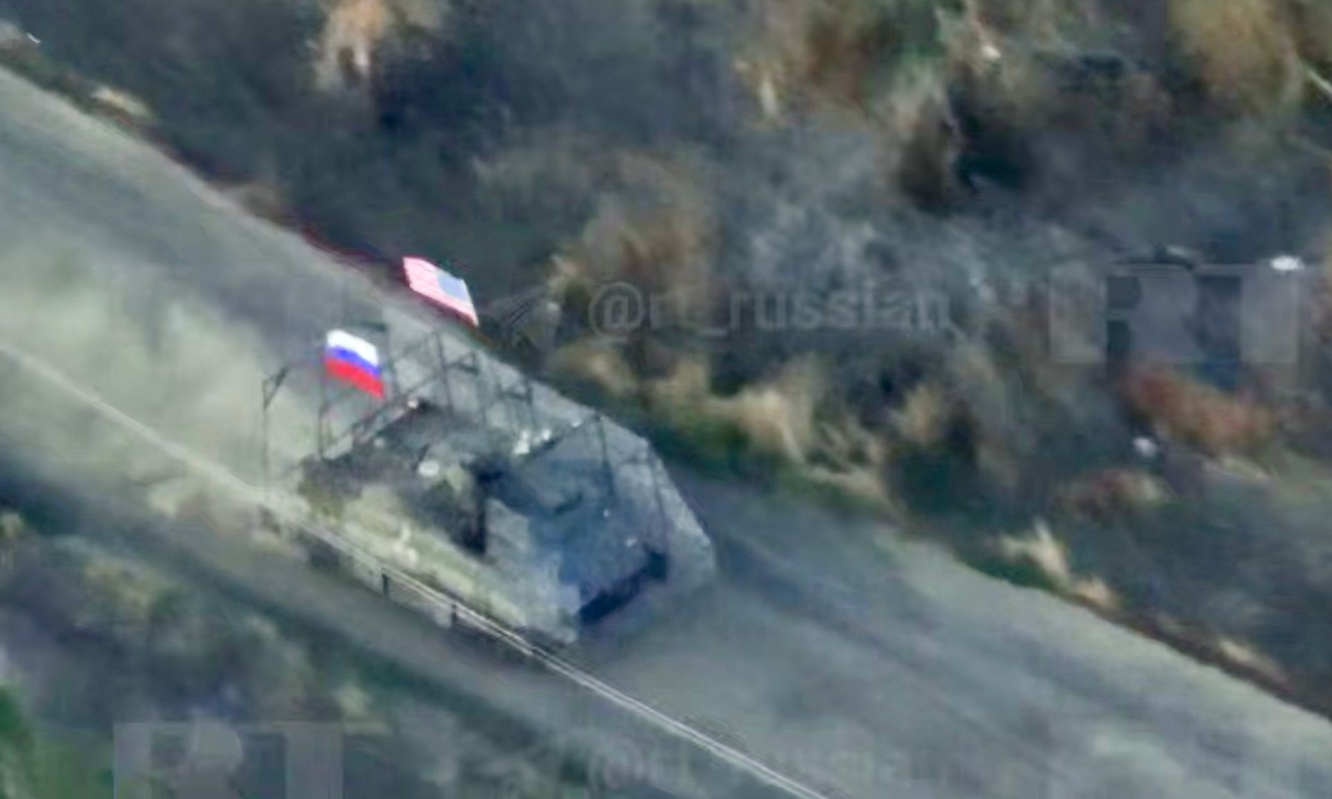 A U.S.-made M113 armored personnel carrier with Russian and American flags attacks Ukrainian positions in Zaporizhzhia Oblast in footage published on Aug. 18, 2025. (Andriy Yermak/Telegram)